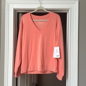Brand new Athleta coral/peach sweatshirt. Very soft. Size Large.